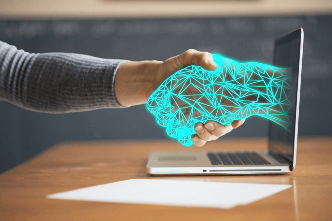 A person shaking hands with a virtual person